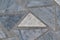 The surface of the triangular marble tiles. In the center of the white triangle, on the edges of the gray triangles