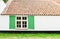 Surface vintage house background with wooden green window open, grung white brick wall and orange concrete roof tiles. Text space