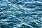 The surface of the water with small waves. Glare on the water. Water background