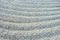 Surface of white gravel texture with grooves symbolic rows in Gravel Stones Garden. Concentric lines of raked up white gravel in Z
