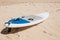 Surfboard lies on the sand on the beach