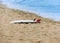 Surfboard lying on sand near the ocean