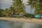 Surfboard and parasol on small Caribbean beach strip