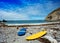 Surfboard on rocky beach near the sea landscape