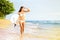 Surfboard woman walking in beach water