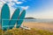 Surfboards are on the rack. Off the coast of the sea with an island in the background