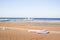 Surfboards standing upright in bright sun on the empty beach/Surf boards on the sand of an empty beach