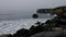 Surfer admires the Pacific waves at Lighthouse Point, Santa Cruz, CA