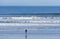 A surfer alone in front of the pacific ocean