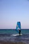 Surfer Balancing and Adjusting the Sail Mast on Surfboard in the Sea. Water Sport Outdoor Adventure for Relaxation