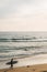 A surfer on the beach in Newport Beach, Orange County, California