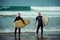 Surfer beginner and instructor on a beach with a surfboards