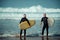 Surfer beginner and instructor on a beach with a surfboards