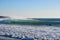 Surfer on Blue & green Ocean Wave riding a surfboard