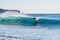 Surfer on Blue & green Ocean Wave riding a surfboard