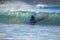 Surfer on Blue & green Ocean Wave riding a surfboard