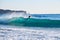 Surfer on Blue & green Ocean Wave riding a surfboard