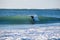 Surfer on Blue & green Ocean Wave riding a surfboard