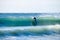 Surfer on Blue & green Ocean Wave riding a surfboard