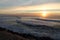 Surfer on breaking wave in colorful scenery of atlantic ocean with mountain la rhune in sunset