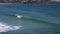 A surfer catches a wave at bondi beach, sydney