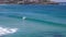 A surfer catches a wave at bondi beach, sydney