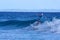 Surfer catching a small wave at Stradbroke Island