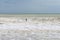 Surfer on a choppy wave in the stormy seas of the English Channel in East Sussex