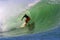 Surfer Clyde Lani Surfing a Tubing Wave