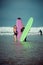 Surfer couple on the beach with a surfing board