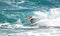 Surfer enjoys a curl as he traverses at big wave off of Boca Beach