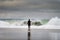 A surfer entering the sea at the Carcavelos Beach in Oeiras