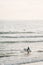 A surfer enters the Pacific Ocean, in Newport Beach, Orange County, California