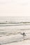 A surfer enters the Pacific Ocean, in Newport Beach, Orange County, California