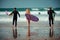 Surfer friends on a beach with a surfing boards