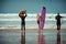 Surfer friends on a beach with a surfing boards