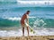 A surfer getting ready for the surf. .Man is applying wax to surfboard shortboard on vacation