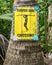 Surfer girl crossing - handpained sign on palm tree.