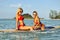 Surfer girls having fun on a surfboard in the sea