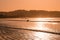 Surfer goes into ocean - silhouette of person with surfboard at