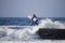 Surfer jumping into water in winter