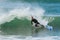 Surfer loses balance and falls off surfboard