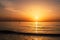 surfer on the north sea at sunset