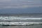 Surfer in the ocean waiting for a wave. Surfers waiting for good surfing waves. Surfers waiting for their wave. Young man waiting