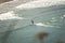 Surfer paddling near the ocean shore