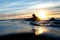 Surfer Paddling Out for One More Wave as Sun Sets