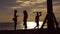 Surfer passes two women on beach