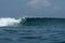 Surfer on perfect blue aquamarine wave, empty line up, perfect for surfing, clean water, Indian Ocean