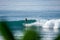 Surfer on perfect blue aquamarine wave, empty line up, perfect for surfing, clean water, Indian Ocean close to Mirissa