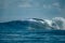 Surfer on perfect blue big tube wave, empty line up, perfect for surfing, clean water in Indian Ocean